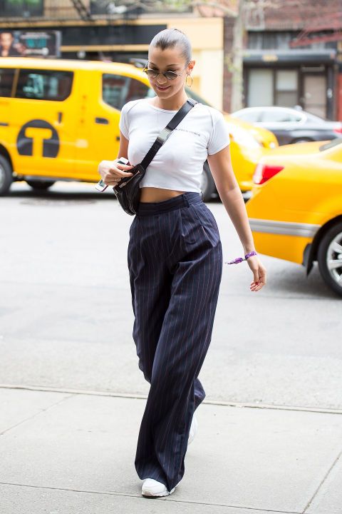 Bella Hadid wearing cropped top,high waist wide leg pants in sporty street style